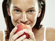 a girl eating an apple